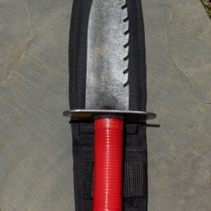 Knife with red handle on black sheath.