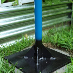 Metal pole base in garden setting.