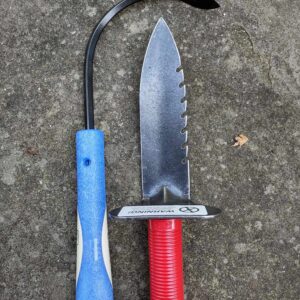 Two gardening tools on concrete surface.