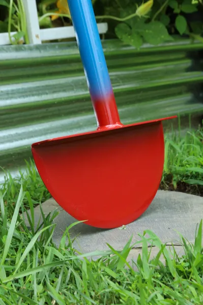 Red garden shovel with blue handle