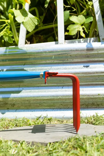 Red garden cultivator tool with blue handle